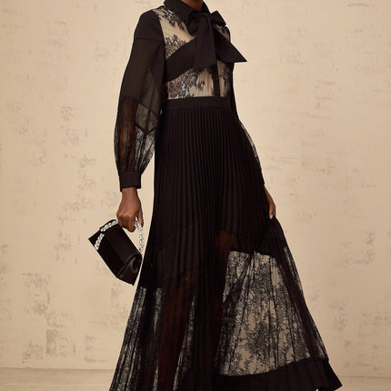 A black maxi dress with pleated skirt and floral lace panels named Segolene