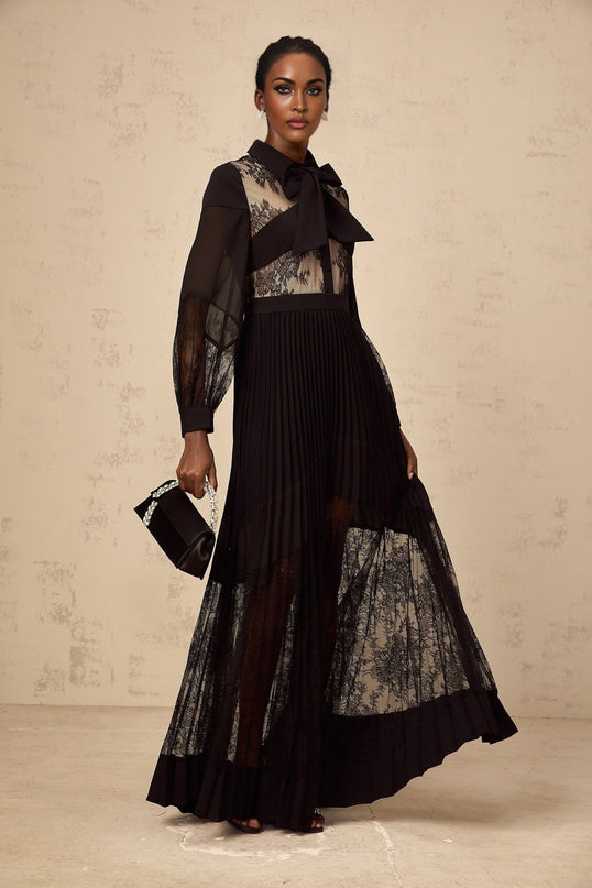 A black maxi dress with pleated skirt and floral lace panels named Segolene