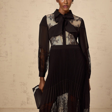 A black maxi dress with pleats and floral lace panels named Segolene