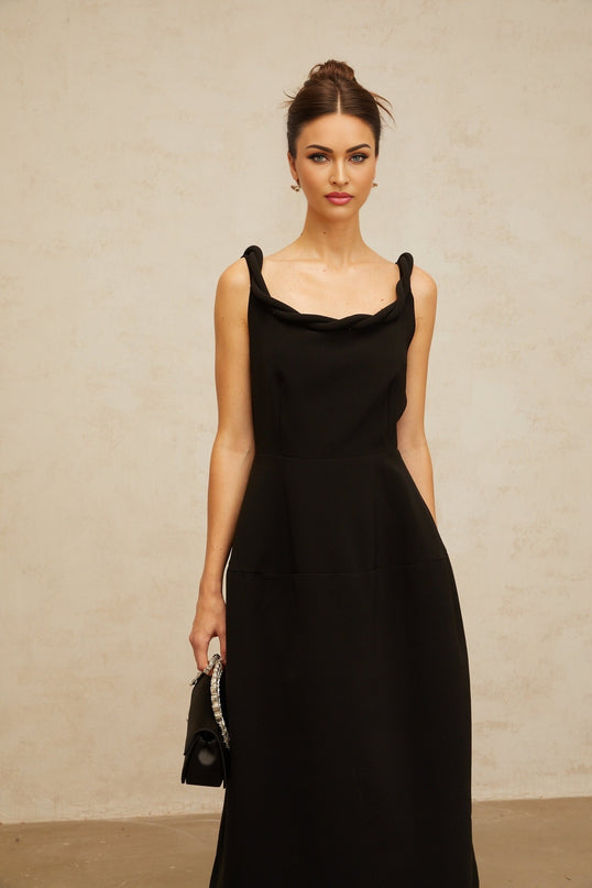 A black midi dress with a braided texture and puff sleeves on a mannequin or model against a plain background