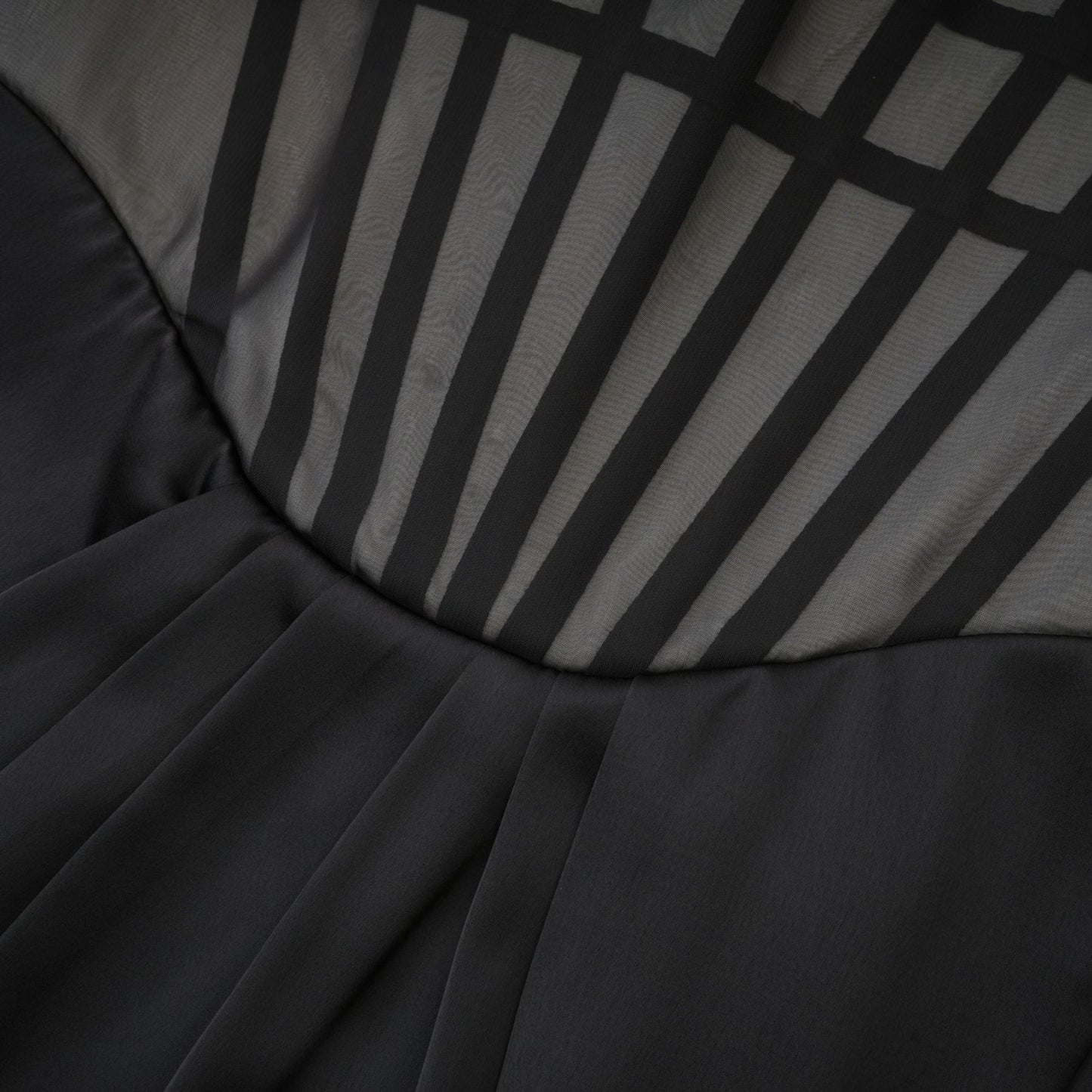 Monochrome chic sleeveless dress with front bowknot corset style ruffled detailing front slit and midi length