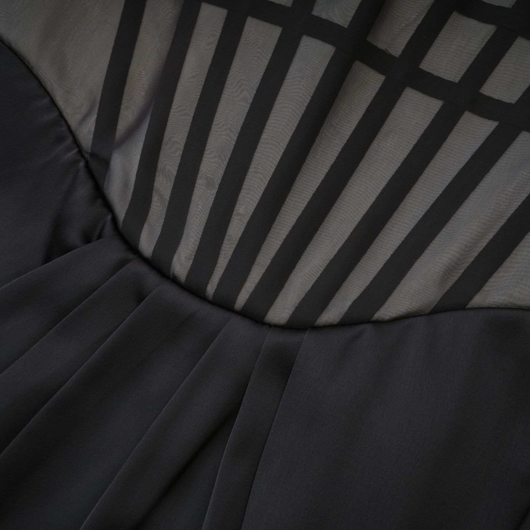 Monochrome chic sleeveless dress with front bowknot corset style ruffled detailing front slit and midi length