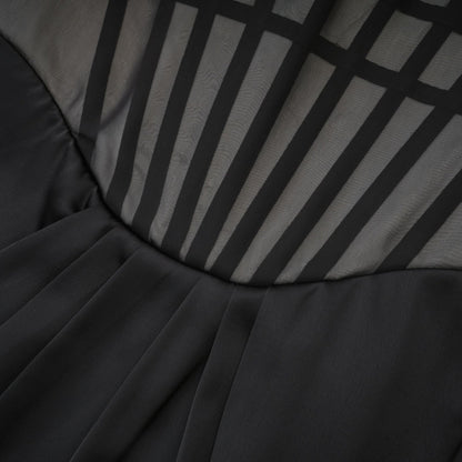 Monochrome chic sleeveless dress with front bowknot corset style ruffled detailing front slit and midi length