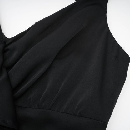 Black sleeveless dress with spaghetti straps flower decoration at the neck ankle length open back made of 100% polyester