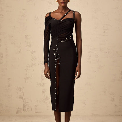 A black midi dress with an asymmetric design and cutout details worn by a model named Louise