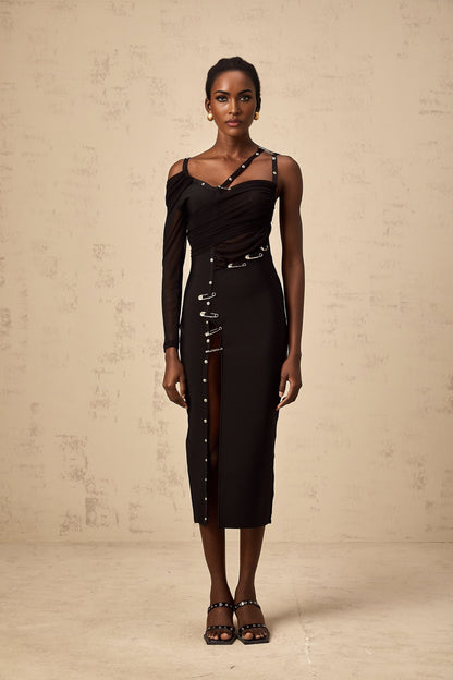 A black midi dress with an asymmetric design and cutout details worn by a model named Louise