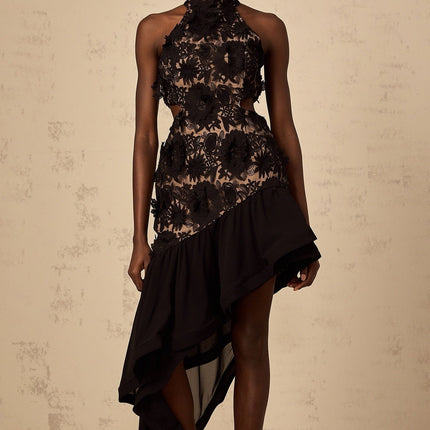 A black midi dress with an asymmetric hem featuring floral applique details named Bernadette
