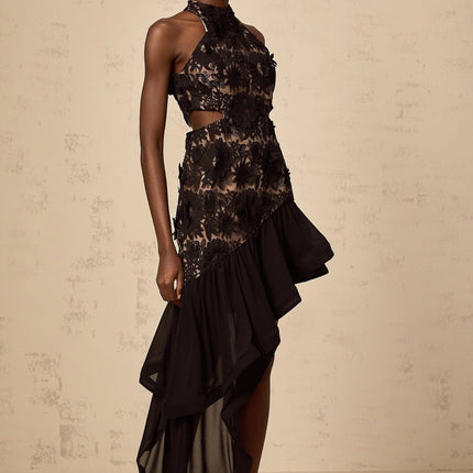 A black midi dress with an asymmetric hemline featuring floral applique details and the name Bernadette visible