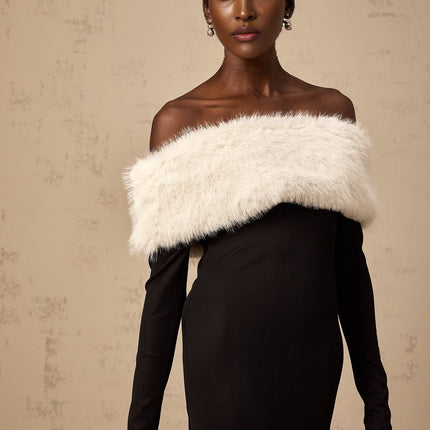 A black midi dress with an offshoulder neckline and faux fur trim worn by a model standing against a plain background