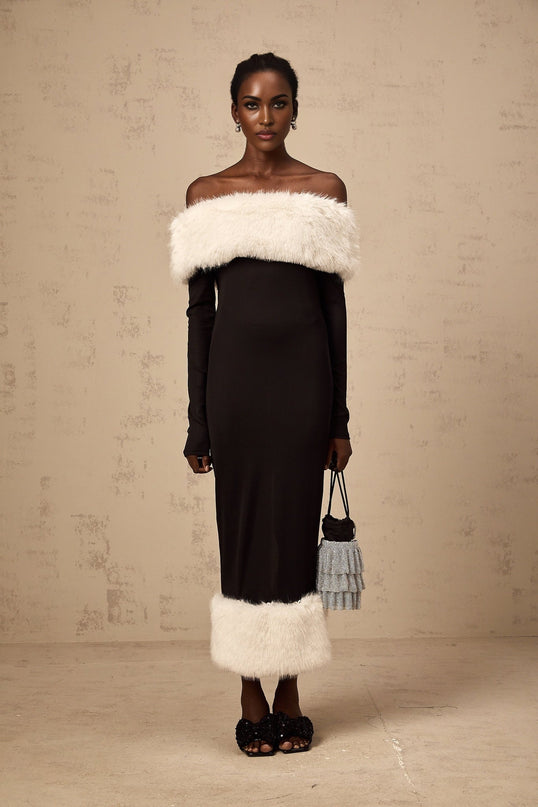 A black midi dress with an offshoulder neckline made of faux fur material featuring a sleek silhouette and a Kendall design