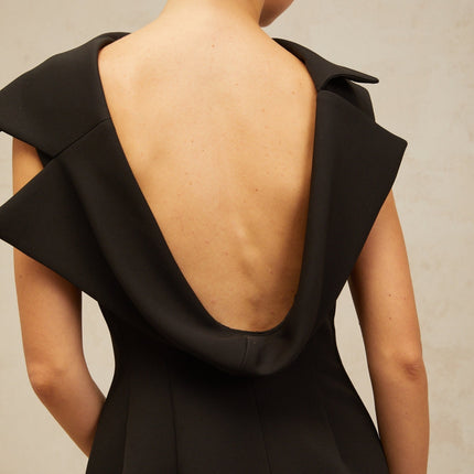 A black midi dress with an open back and deconstructed design elements named Leonore
