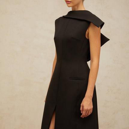A black midi dress with an open back and deconstructed design features named Leonore