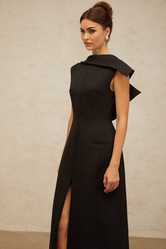 A black midi dress with an open back and deconstructed design features named Leonore