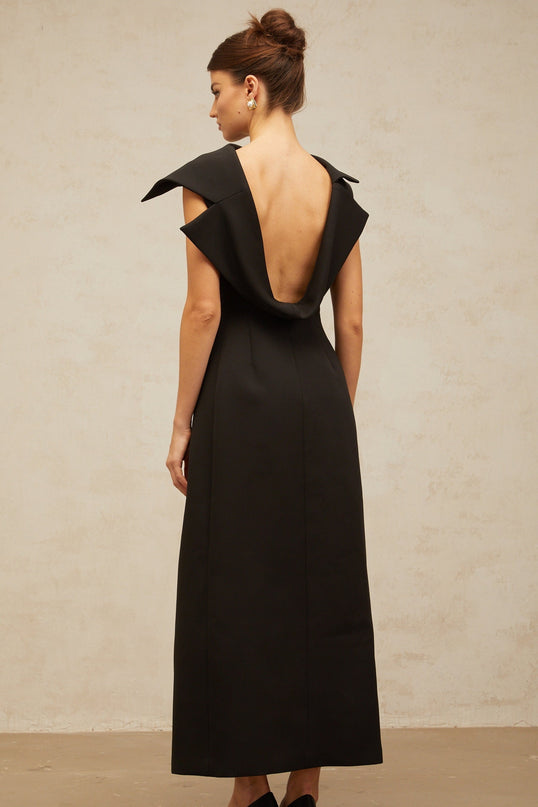 A black midi dress with an open back and deconstructed design featuring a sleek silhouette and elegant style
