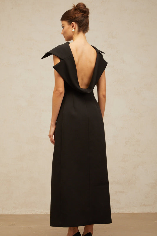 A black midi dress with an open back and deconstructed design featuring a sleek silhouette and elegant style