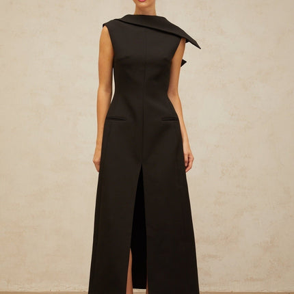 A black midi dress with an open back and deconstructed design featuring Leonore style