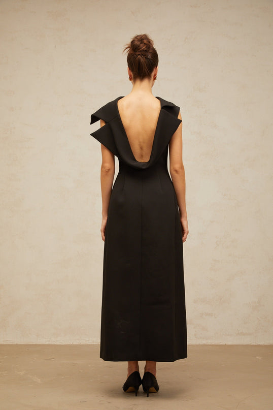 A black midi dress with an open back and deconstructed design named Leonore