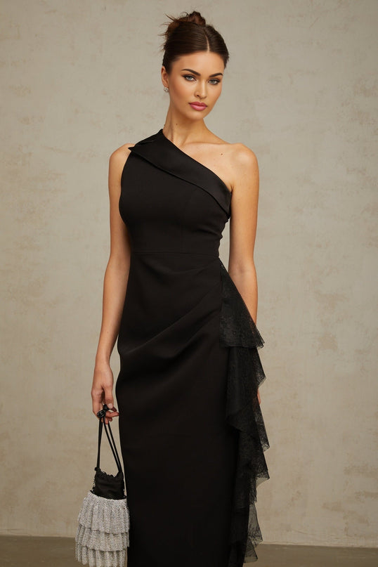 A black midi dress with asymmetric hem featuring lace panel details and named Bernadette