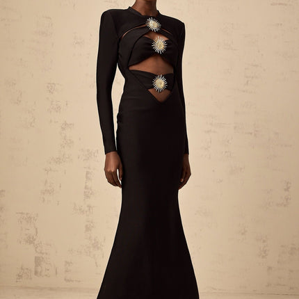 A black midi dress with cutout details featuring a sun motif design and ruched fabric Astrid collection