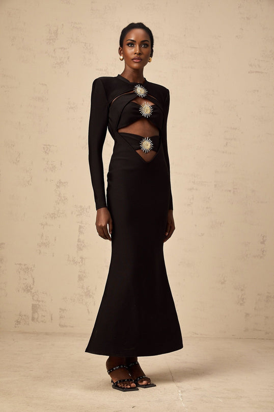 A black midi dress with cutout details featuring a sun motif design and ruched fabric Astrid collection