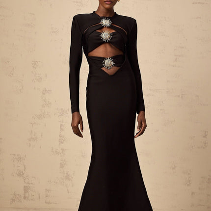 A black midi dress with cutout details featuring a sun motif pattern and ruched fabric Astrid design with a fitted silhouette and mid length skirt