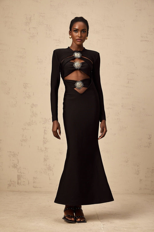 A black midi dress with cutout details featuring a sun motif pattern and ruched fabric Astrid design with a fitted silhouette and mid length skirt