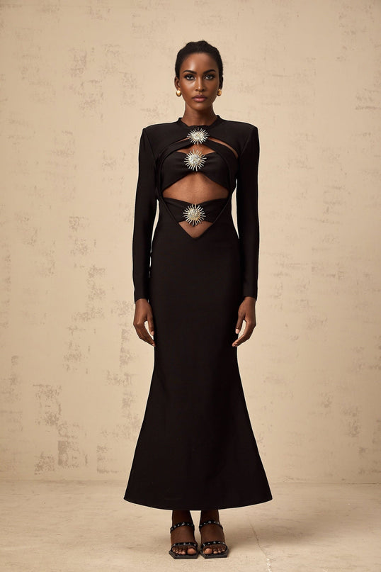 A black midi dress with cutout details featuring a sun motif pattern and ruched fabric Astrid style with a form fitting silhouette