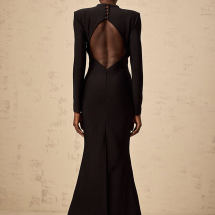 A black midi dress with cutout details featuring a sun motif pattern and ruched fabric Astrid style with a formfitting silhouette