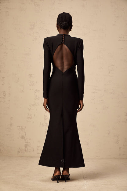 A black midi dress with cutout details featuring a sun motif pattern and ruched fabric Astrid style with a formfitting silhouette