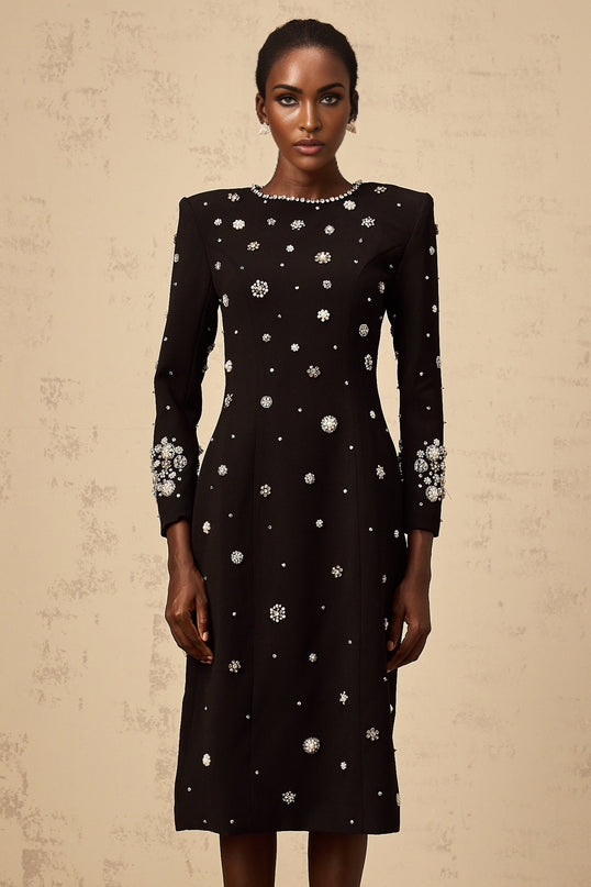 A black midi dress with dart details and embellishments designed by Gaelle