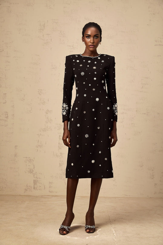 A black midi dress with dart details and embellishments designed by Gaelle