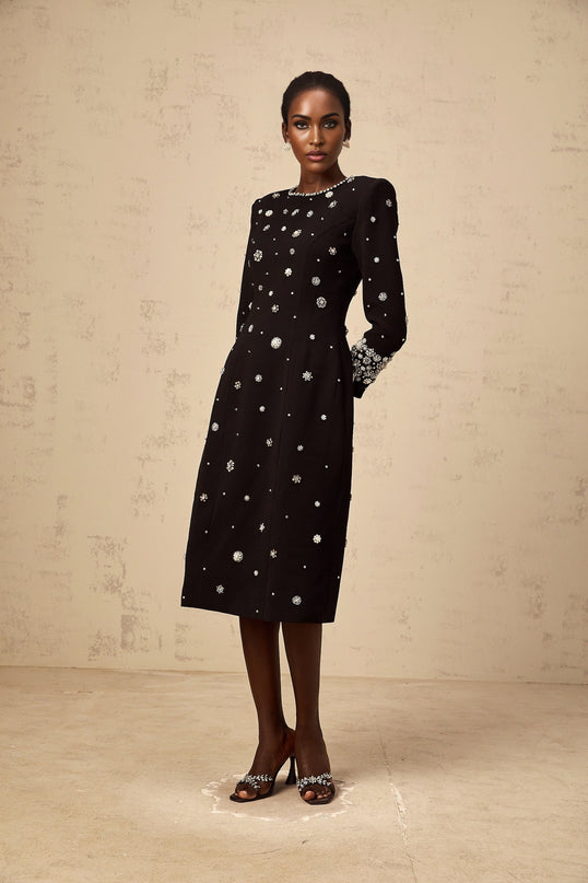 A black midi dress with dart details and embellishments designed by Gaelle