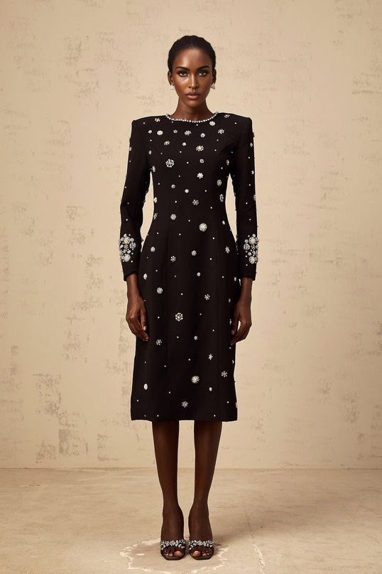 A black midi dress with dart details and embellishments designed by Gaëlle