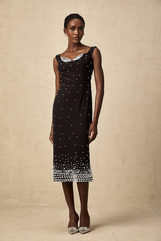 A black midi dress with faux pearl embellishments called Apolline