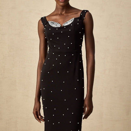 A black midi dress with faux pearl embellishments called Apolline
