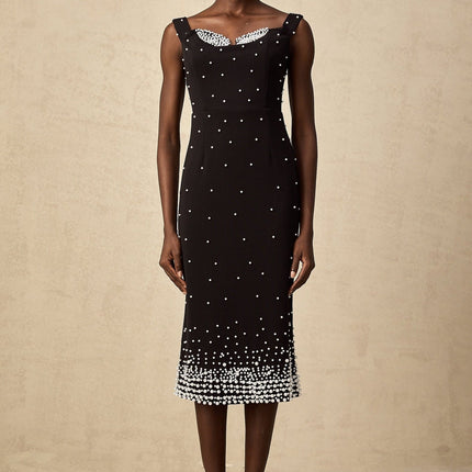 A black midi dress with faux pearl embellishments called Apolline