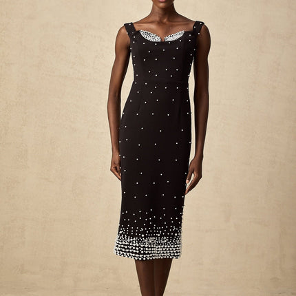 A black midi dress with faux pearl embellishments called Apolline