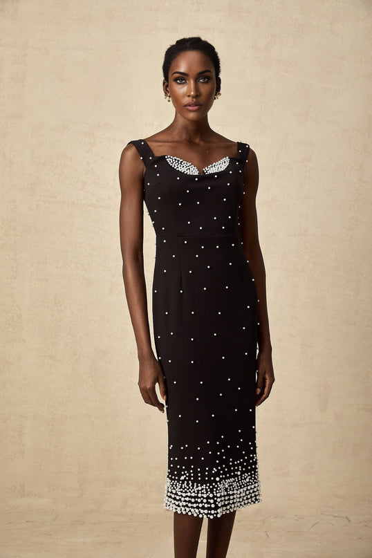A black midi dress with faux pearl embellishments called Apolline