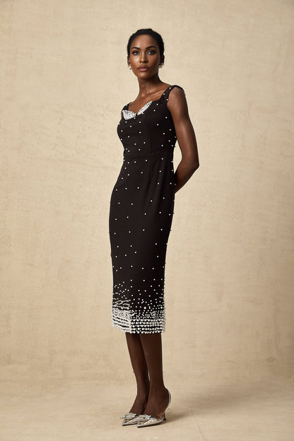 A black midi dress with faux pearl embellishments named Apolline