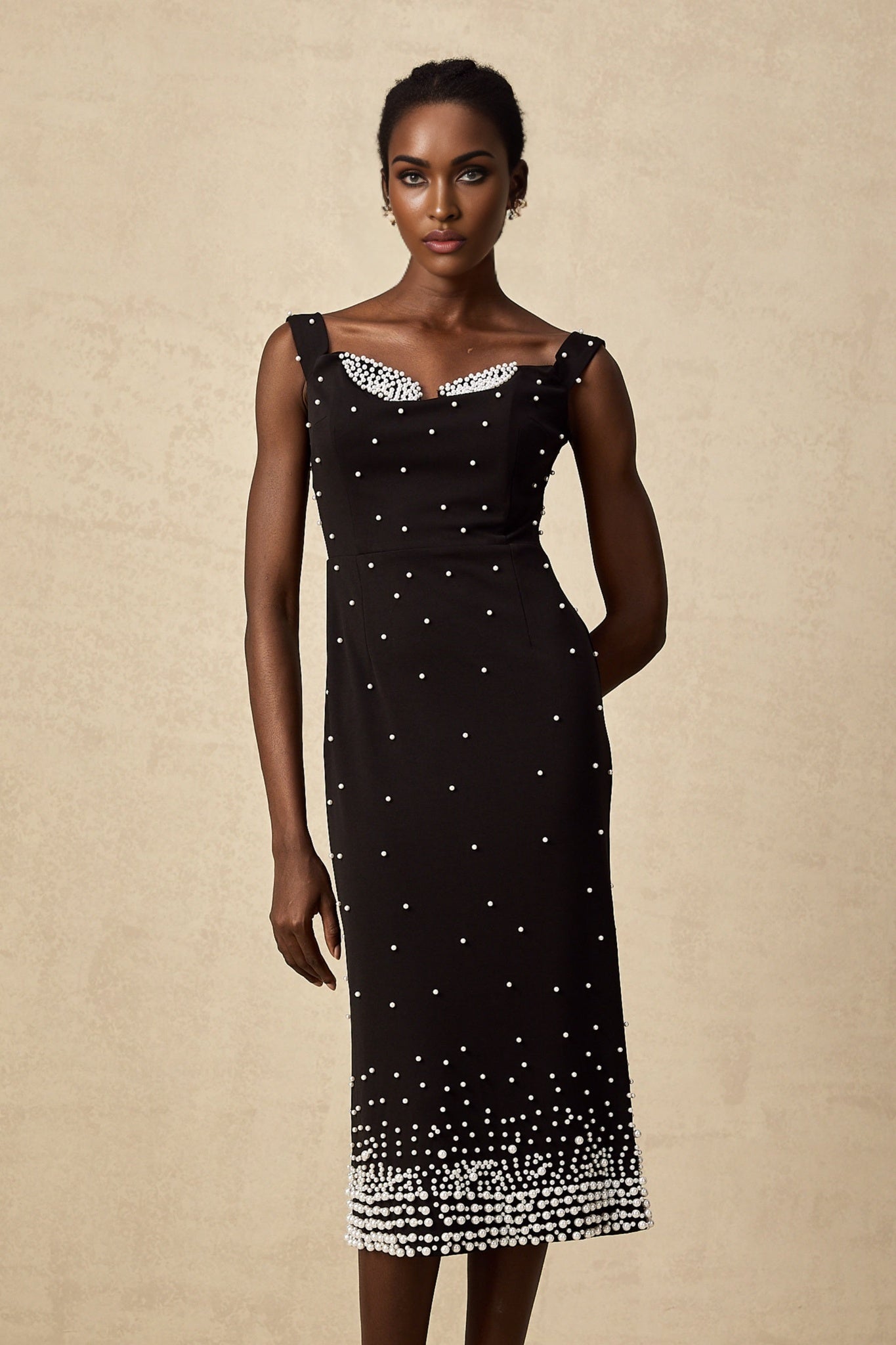A black midi dress with faux pearl embellishments named Apolline