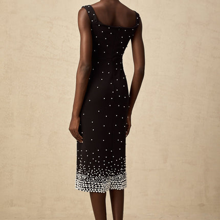 A black midi dress with faux pearl embellishments on the bodice named Apolline