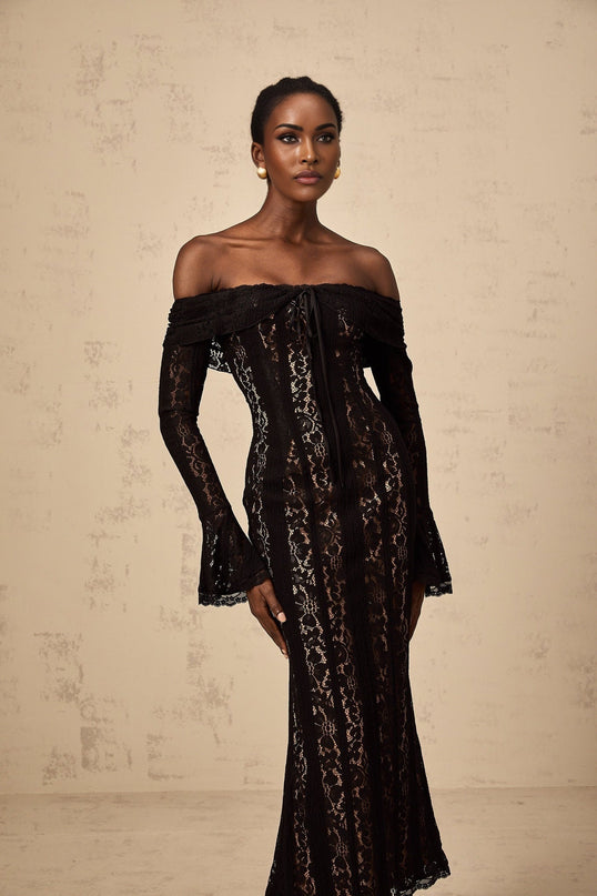 A black midi dress with floral lace detailing and flared cuffs named Émeline shown on a model or mannequin