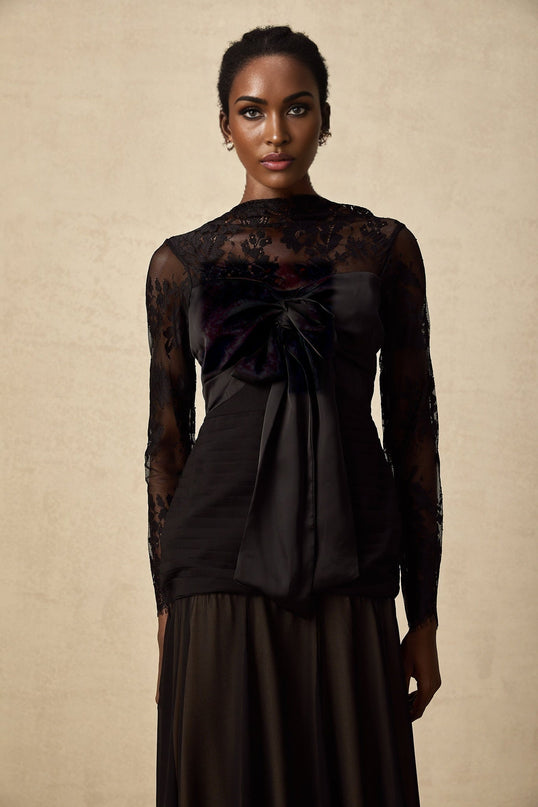 A black midi dress with floral lace panels and a feminine silhouette named Amelie