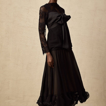 A black midi dress with floral lace panels and a fitted silhouette named Amelie