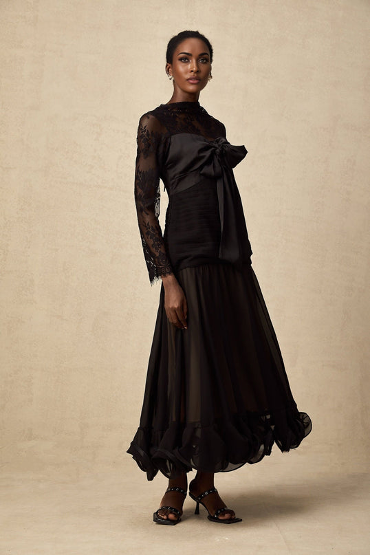 A black midi dress with floral lace panels and a fitted silhouette named Amelie