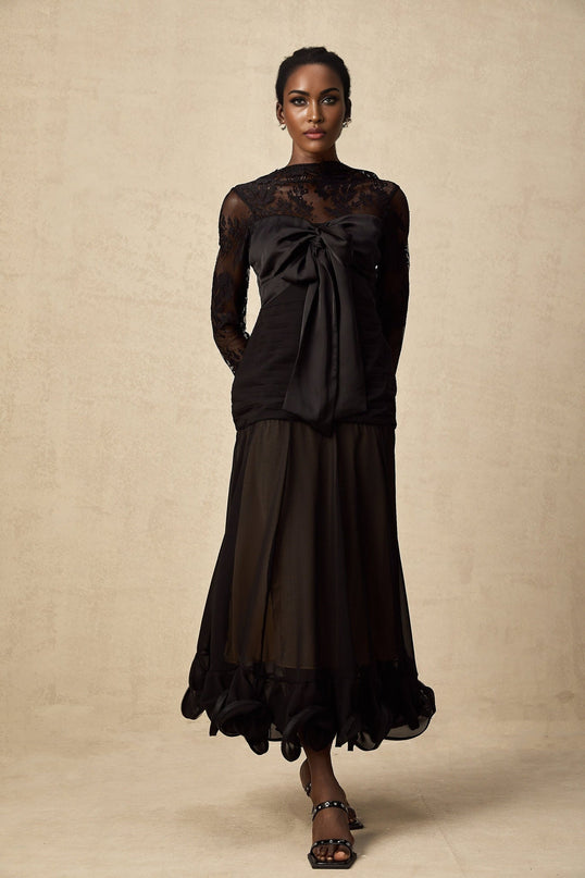 A black midi dress with floral lace panels and sheer details named Amelie
