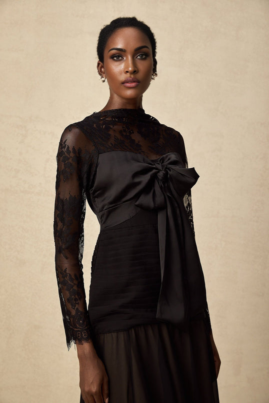 A black midi dress with floral lace panels named Amelie featuring a fitted silhouette and elegant design