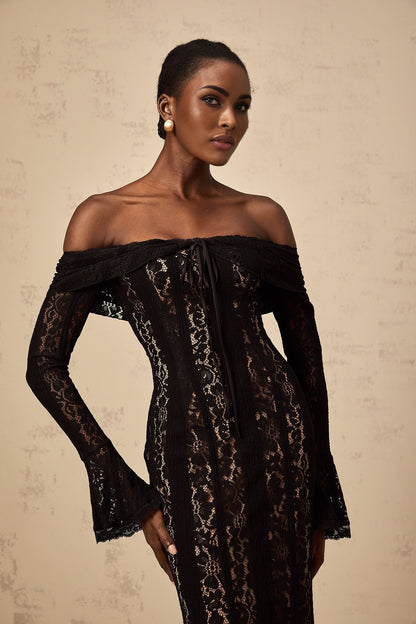 A black midi dress with floral lace pattern and flared cuffs named Émeline on a plain background