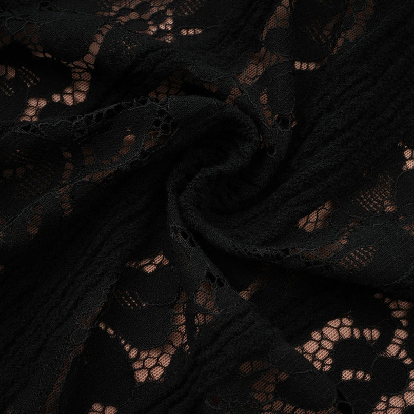 A black midi dress with floral lace pattern and flared cuffs named Émeline