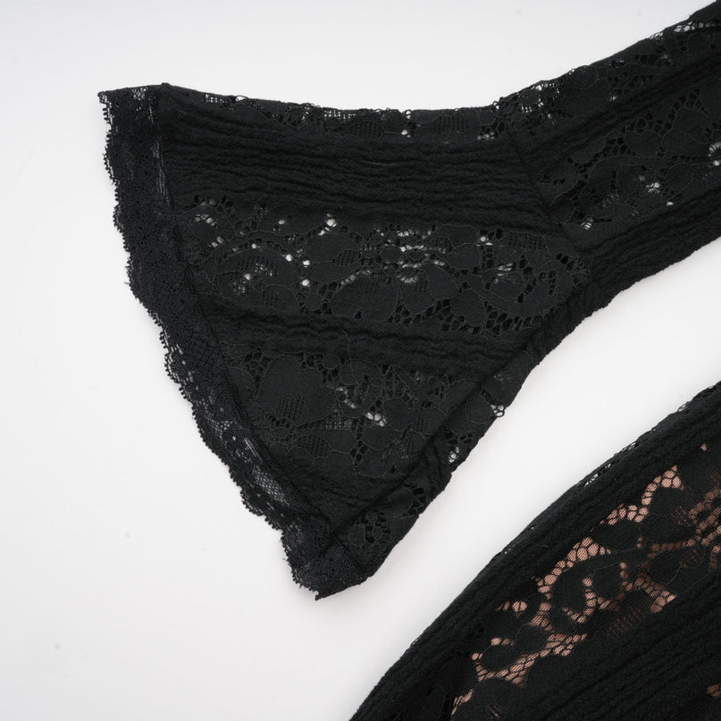 A black midi dress with floral lace pattern and flared cuffs named Émeline